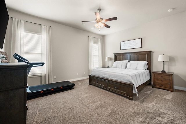 carpeted bedroom with multiple windows and ceiling fan