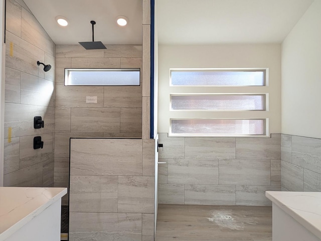 bathroom featuring vanity and tiled shower