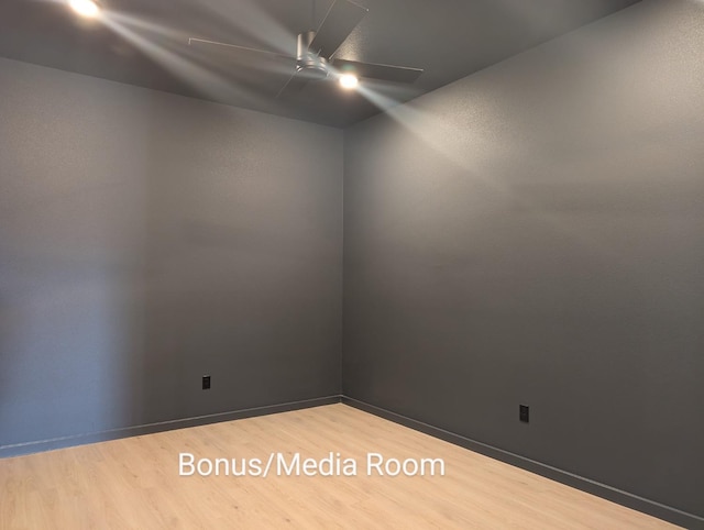 empty room featuring hardwood / wood-style floors and ceiling fan