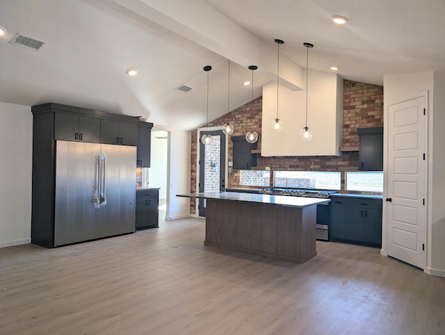 kitchen featuring hanging light fixtures, vaulted ceiling with beams, a center island, light hardwood / wood-style floors, and stainless steel built in fridge