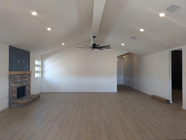 unfurnished living room featuring ceiling fan, light hardwood / wood-style floors, and vaulted ceiling with beams