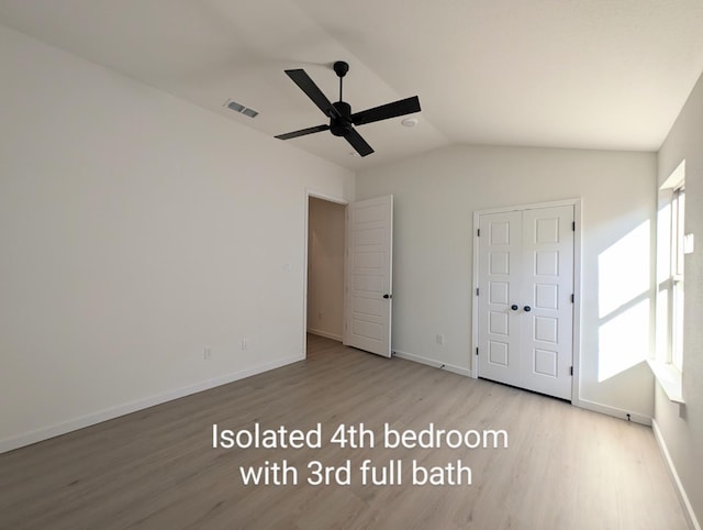 unfurnished bedroom featuring ceiling fan, lofted ceiling, and light wood-type flooring