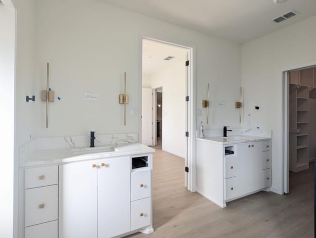 bathroom featuring vanity and hardwood / wood-style floors