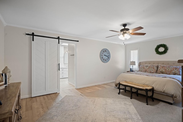 bedroom featuring ornamental molding, a barn door, and light wood-type flooring