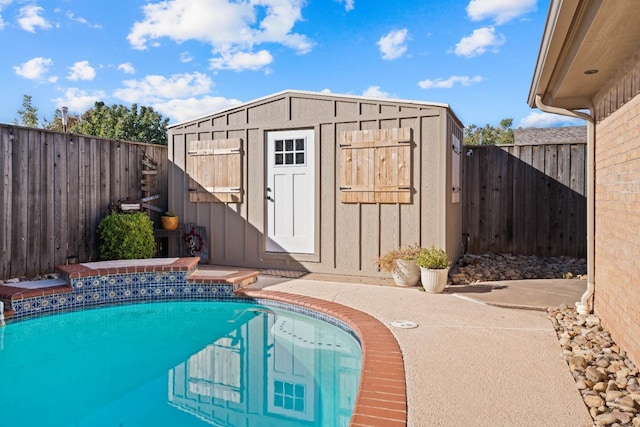 view of swimming pool with a shed