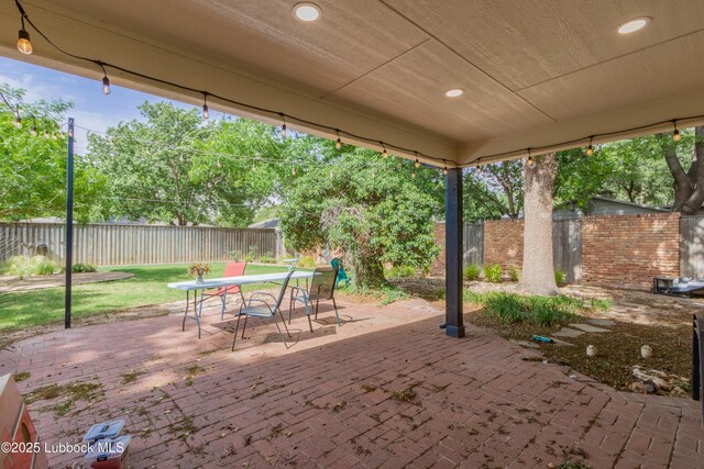 3014 25th St, Lubbock, TX 79410 - fenced backyard with outdoor dining area and a patio area
