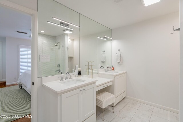 3014 25th St, Lubbock, TX 79410 - full bathroom featuring vanity, a shower stall, ensuite bathroom, and baseboards