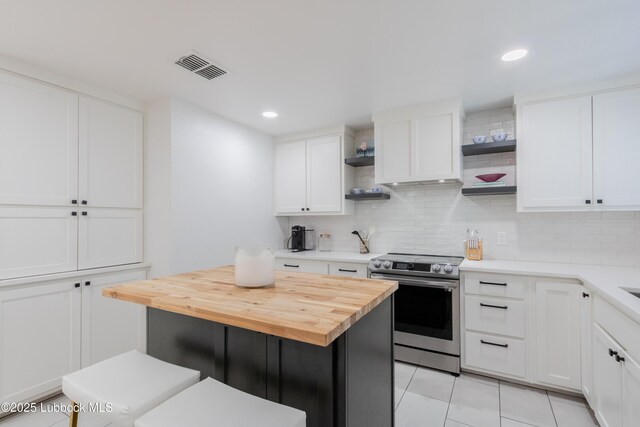 3014 25th St, Lubbock, TX 79410 - kitchen featuring open shelves, stainless steel electric stove, butcher block counters, tasteful backsplash, and white cabinets