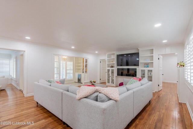3014 25th St, Lubbock, TX 79410 - living area with ornamental molding, light wood-style flooring, baseboards, recessed lighting, and built in shelves