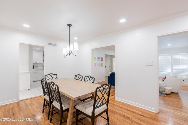 3014 25th St, Lubbock, TX 79410 - dining area with light wood finished floors, crown molding, a chandelier, recessed lighting, and baseboards