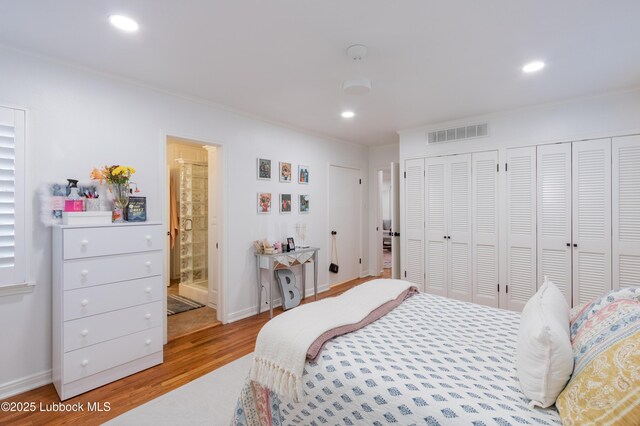 3014 25th St, Lubbock, TX 79410 - bedroom featuring multiple closets, wood finished floors, crown molding, recessed lighting, and ensuite bath