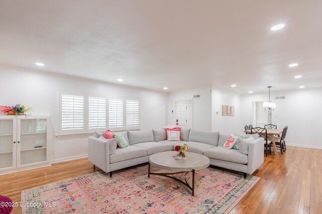 3014 25th St, Lubbock, TX 79410 - living room with light wood-type flooring, recessed lighting, a chandelier, and baseboards
