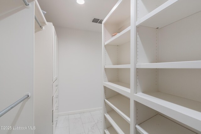 3014 25th St, Lubbock, TX 79410 - walk in closet featuring light marble finish floors