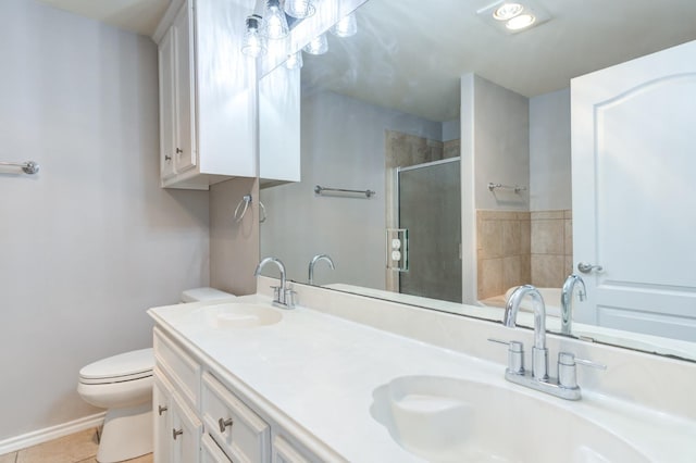 bathroom featuring an enclosed shower, vanity, tile patterned floors, and toilet