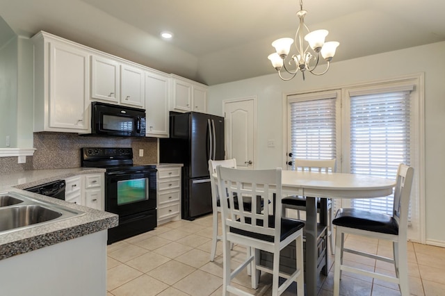 kitchen with white cabinetry, decorative light fixtures, black appliances, and light tile patterned flooring