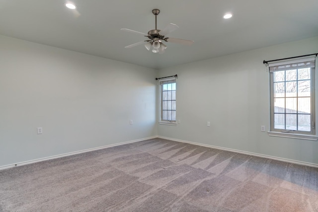 carpeted empty room featuring ceiling fan