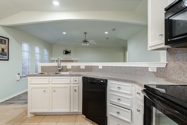 kitchen featuring sink, light tile patterned floors, tasteful backsplash, black appliances, and white cabinets