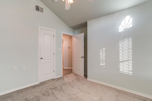 unfurnished bedroom with light carpet, vaulted ceiling, and ceiling fan