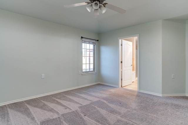 unfurnished room featuring light carpet and ceiling fan