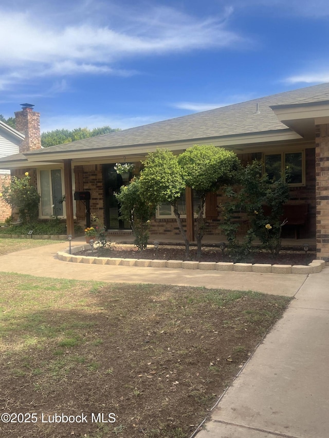 5226 92nd St, Lubbock, TX 79424 - view of front of home featuring a chimney and a shingled roof