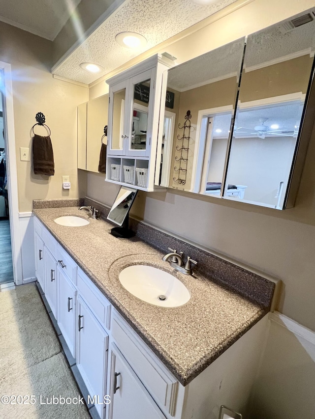 5226 92nd St, Lubbock, TX 79424 - full bathroom featuring double vanity, crown molding, and a textured ceiling