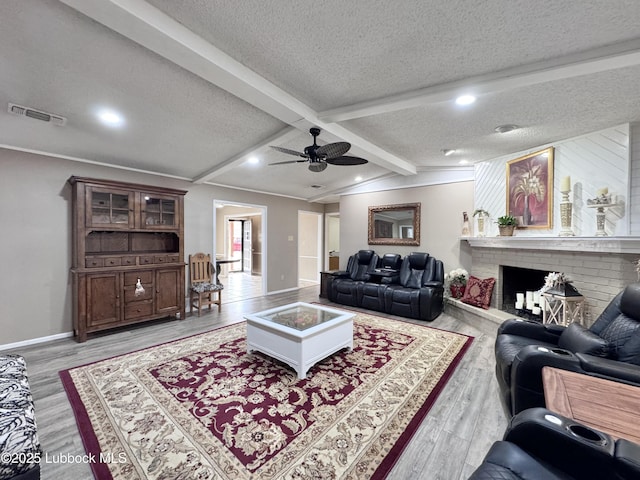 5226 92nd St, Lubbock, TX 79424 - living room with a textured ceiling, beam ceiling, light wood-style floors, a ceiling fan, and baseboards
