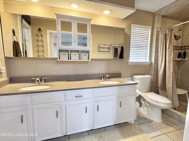 5226 92nd St, Lubbock, TX 79424 - full bathroom with toilet, tile patterned flooring, a tile shower, and double vanity
