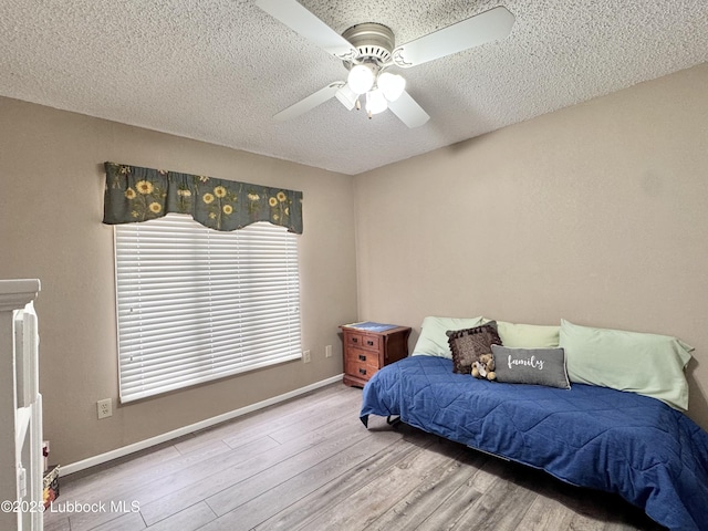 5226 92nd St, Lubbock, TX 79424 - bedroom featuring wood finished floors, a textured ceiling, ceiling fan, and baseboards