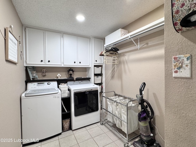5226 92nd St, Lubbock, TX 79424 - washroom featuring cabinet space, washer and dryer, light tile patterned floors, a textured ceiling, and a textured wall