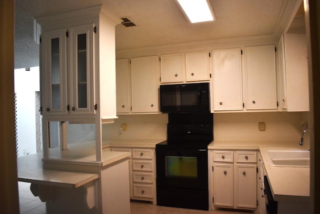 kitchen featuring white cabinetry, sink, and black appliances