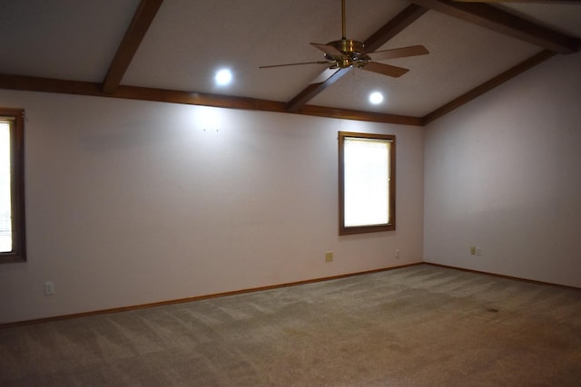 empty room with lofted ceiling with beams, carpet, and ceiling fan