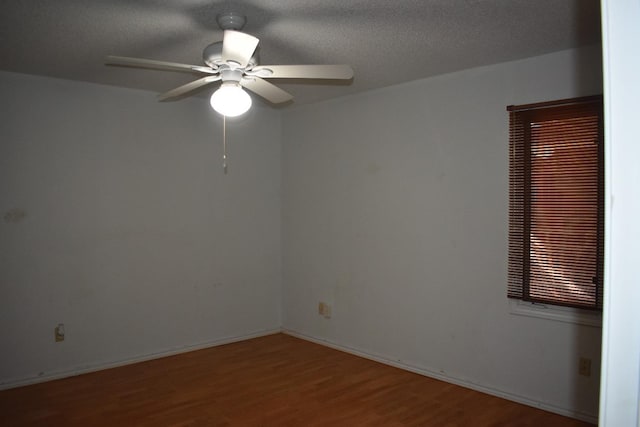 spare room with wood-type flooring, ceiling fan, and a textured ceiling