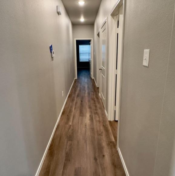 hall with dark hardwood / wood-style flooring