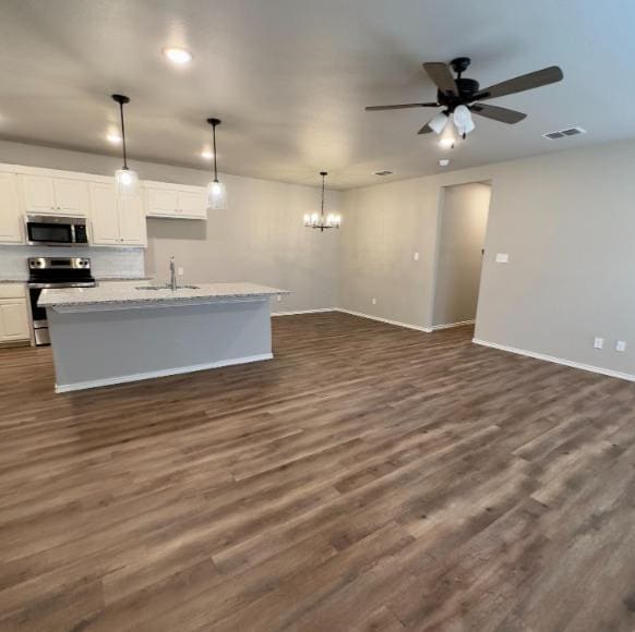 kitchen with white cabinetry, dark hardwood / wood-style floors, and stainless steel appliances