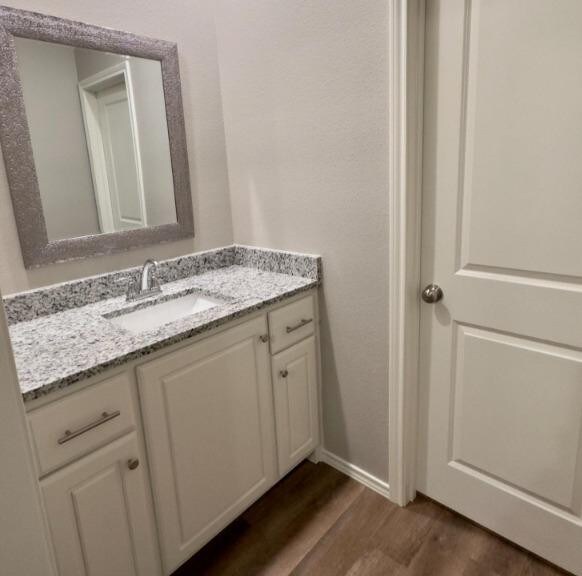 bathroom with vanity and hardwood / wood-style floors