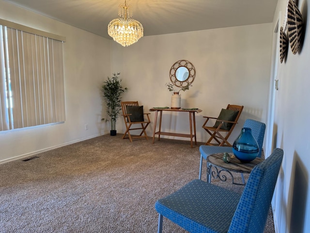 sitting room featuring a chandelier and carpet