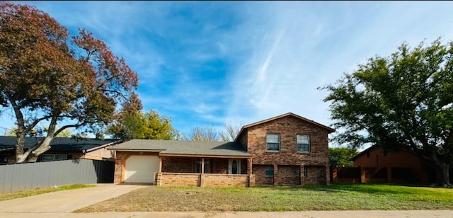 view of front of property with a garage and a front lawn