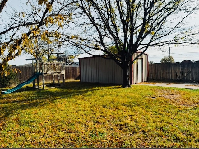 view of yard featuring an outdoor structure and a playground