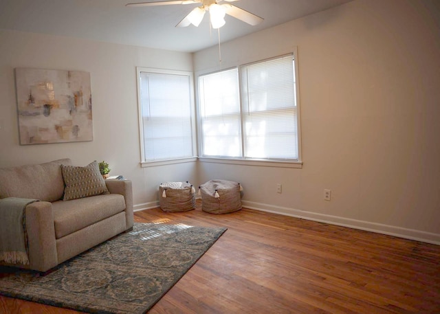 sitting room featuring wood-type flooring and ceiling fan