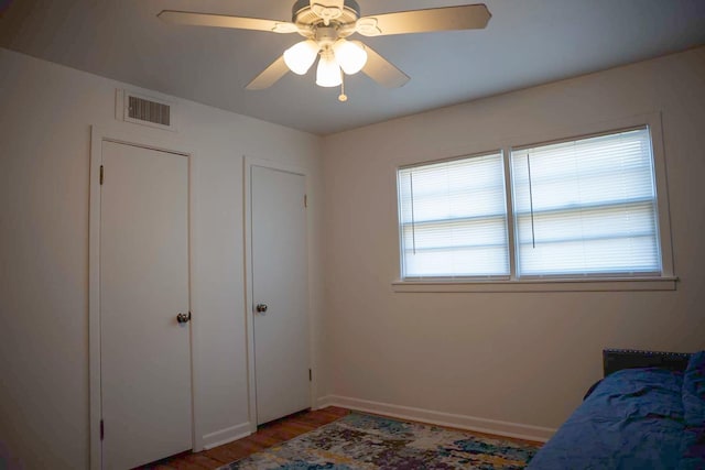 bedroom featuring dark hardwood / wood-style floors and ceiling fan