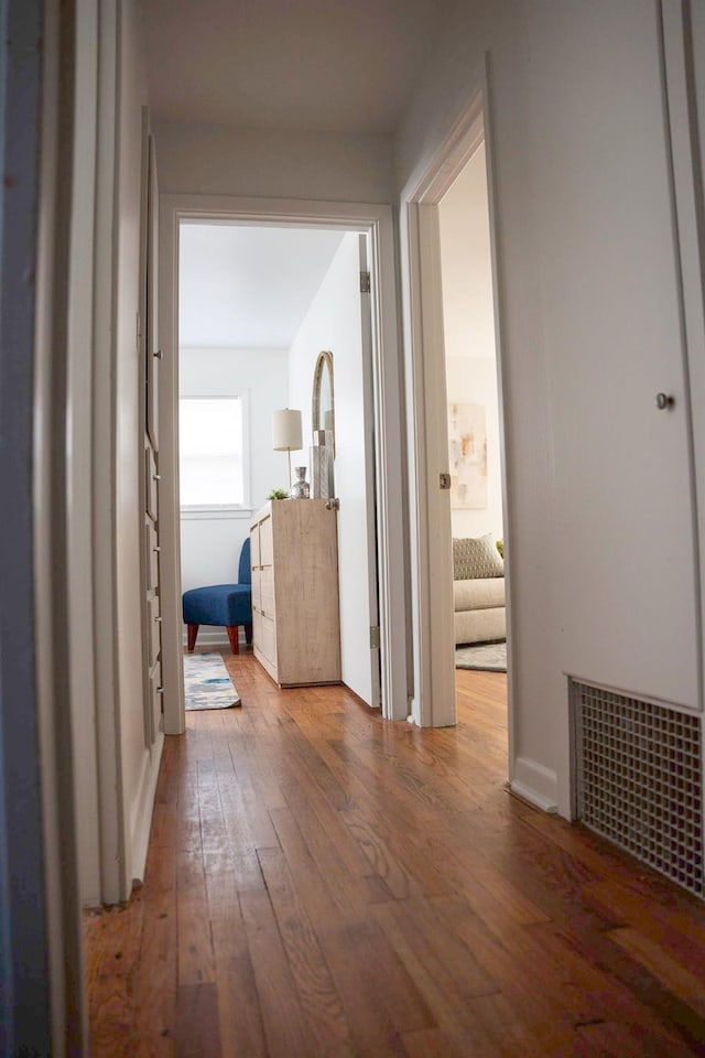 hall with hardwood / wood-style floors