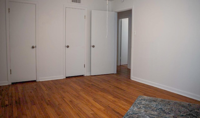 unfurnished bedroom with wood-type flooring