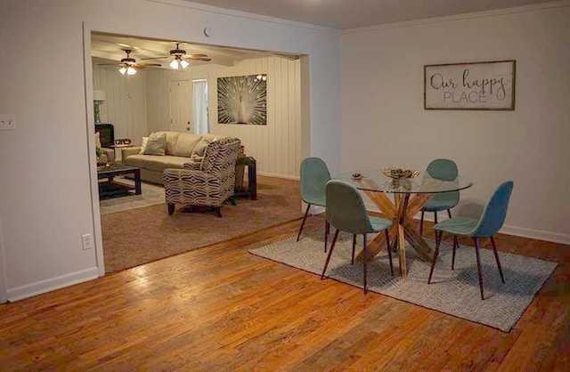 dining room with ornamental molding and hardwood / wood-style floors