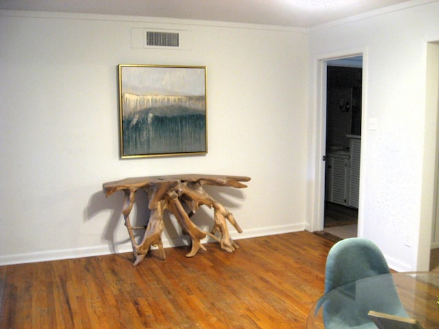 dining room featuring ornamental molding and wood-type flooring