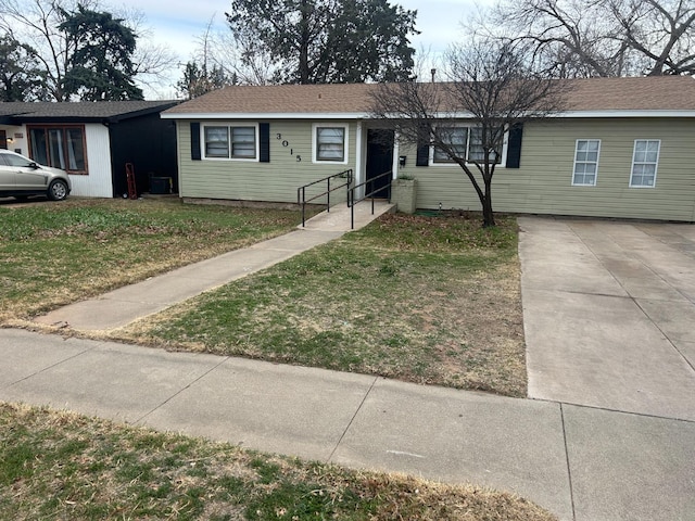 single story home with central AC and a front yard