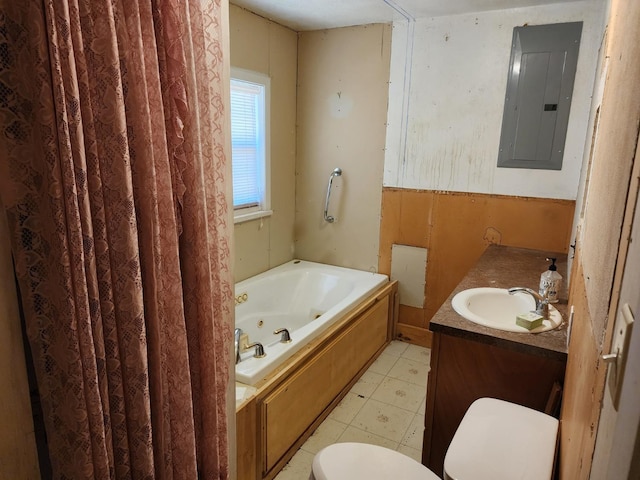 bathroom featuring vanity, a tub to relax in, electric panel, and toilet