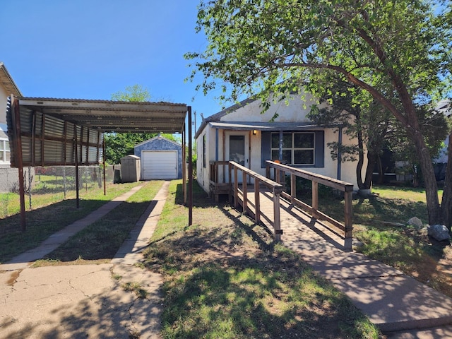 view of front of house featuring a carport, a garage, and an outdoor structure