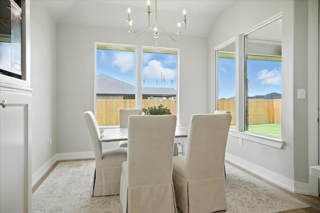 1403 Durham Ave, Wolfforth, TX 79382 - dining space featuring a chandelier, wood finished floors, and vaulted ceiling