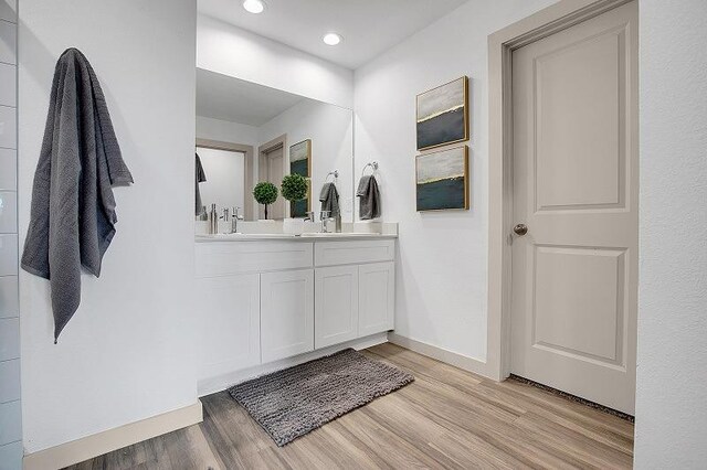 bathroom with wood-type flooring and vanity