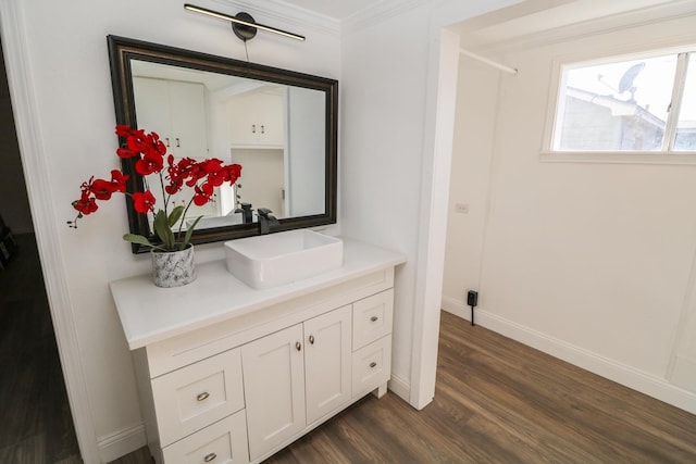 bathroom with vanity, hardwood / wood-style floors, and ornamental molding